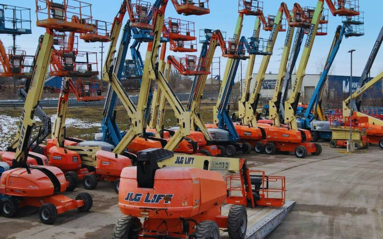 Mixed fleet of heavy equipment lined up at a UAE project site
